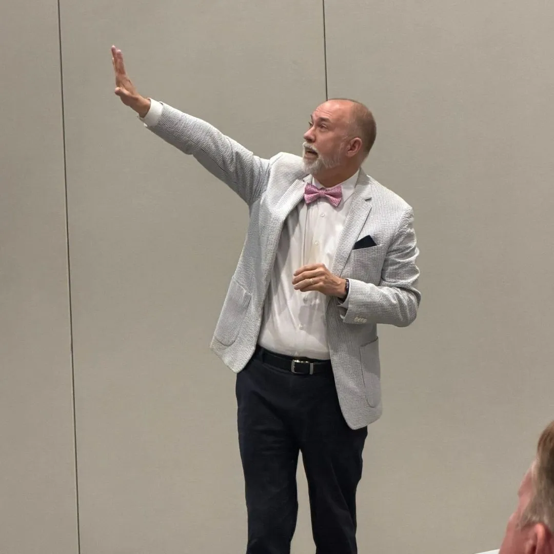 Casey Jaynes speaking to an audience about public education and leadership