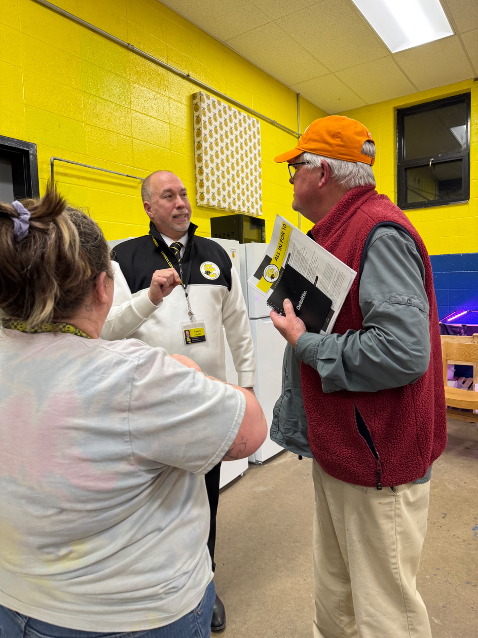 Casey Jaynes speaking with community members at a school event